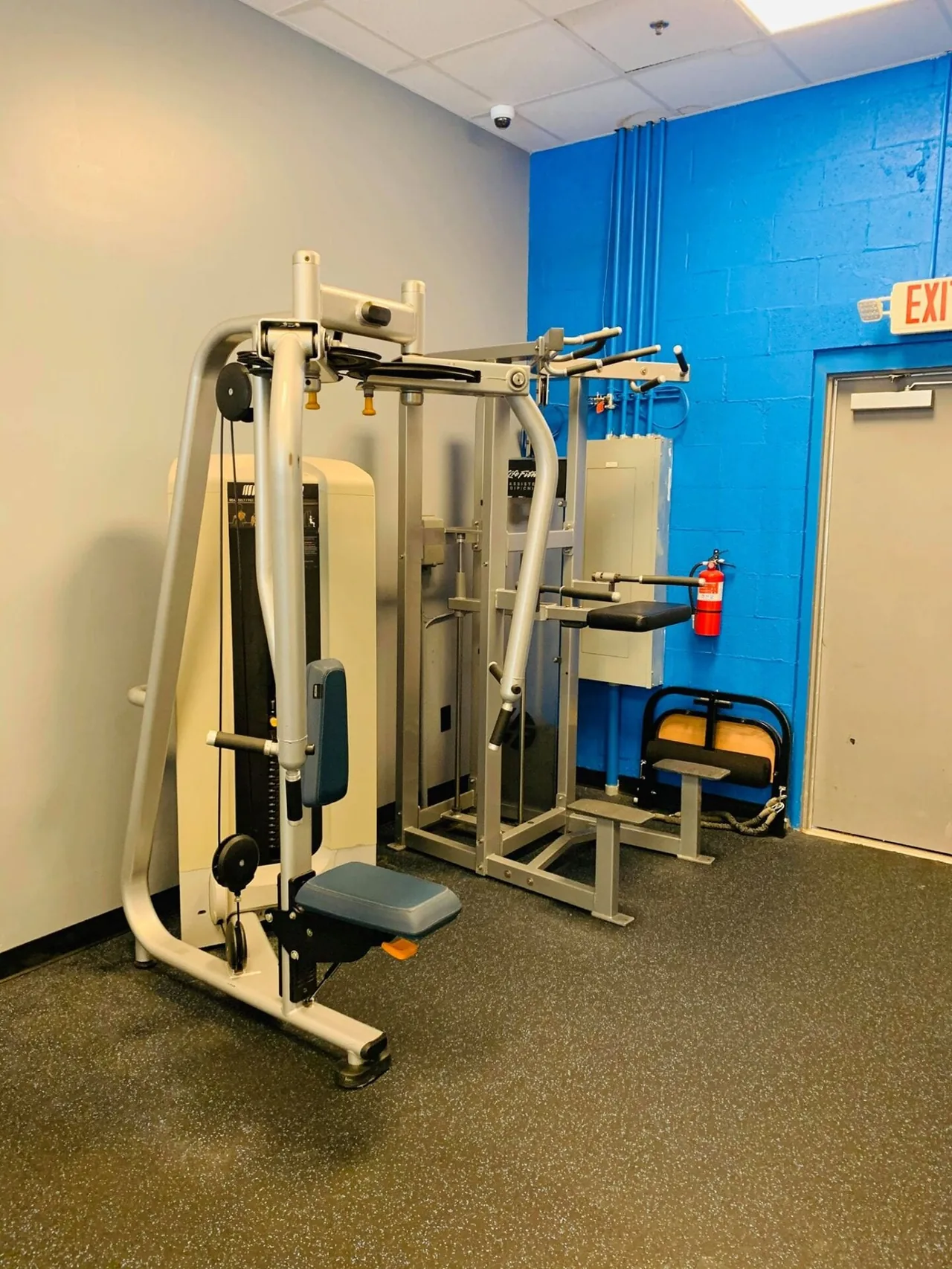 Multi-station chest and back machine on a non-slip rubber floor.