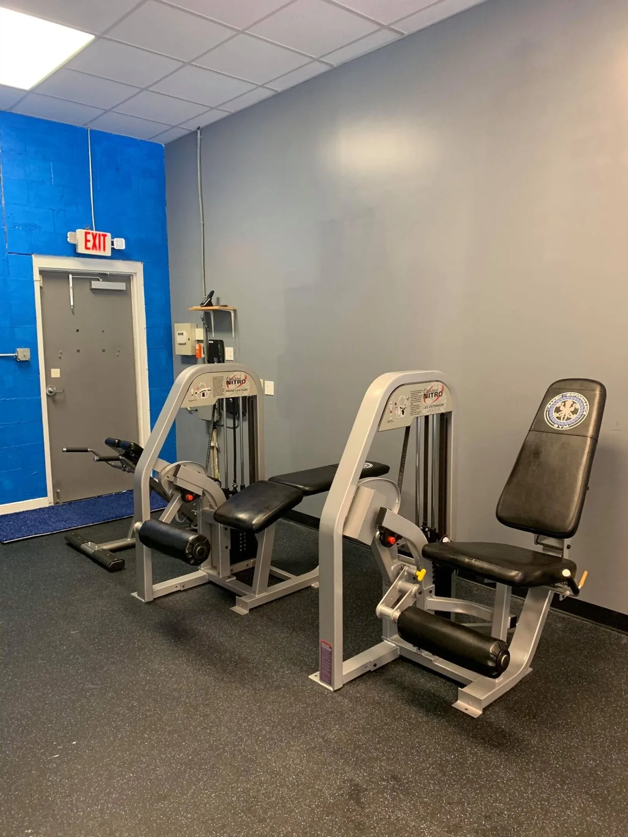 Nitro leg curl and leg extension machines along the wall.