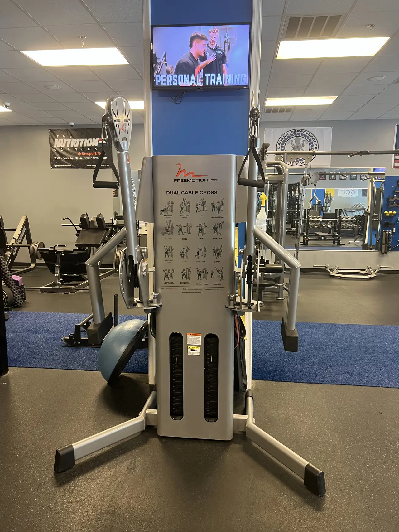 Freemotion EXT dual cable cross with its exercise chart, below the personal-training screen.